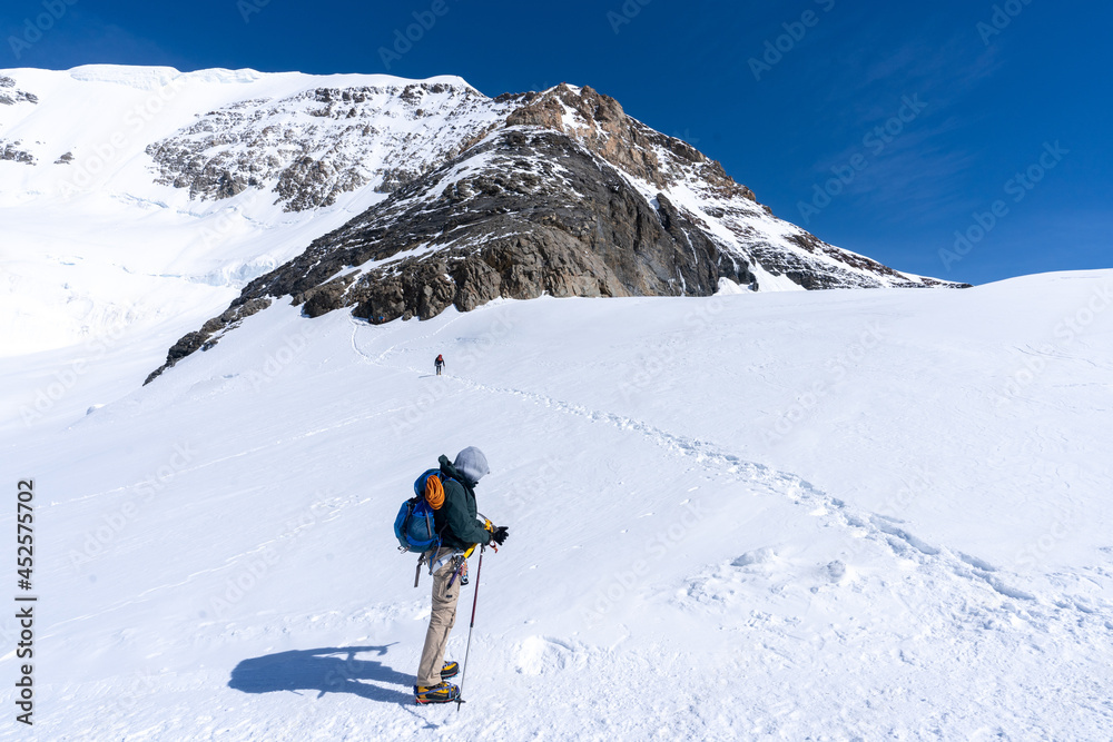 Εκτύπωση καμβά un homme qui s'apprête à monter en haut du sommet d'une montagne enneigée