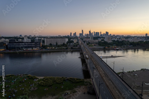 wieżowce w cetrum Warszawy, rzeka Wisła, plaża o zachodzie słońca z lotu ptaka, dron