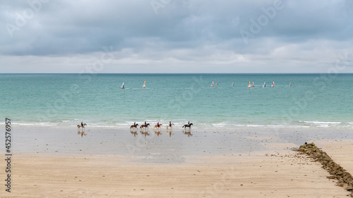 Beautiful beach at Agon-Coutainville in Normandy, with sailers and riders 
 photo