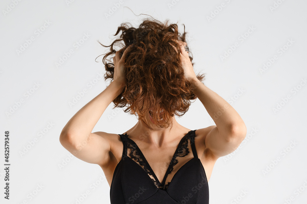 Woman tears her short messy hair and screams in despair Woman tears her short messy hair and screams in despair