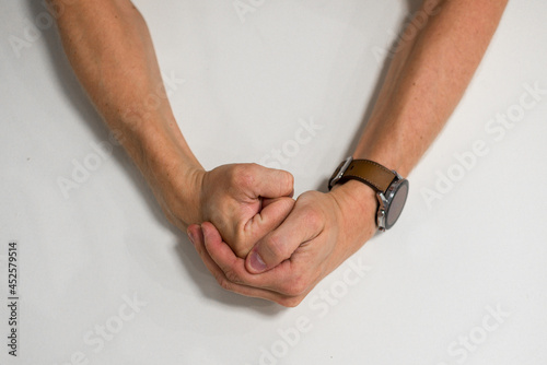 Close-up of a man s fist. Strong and power man s hand with smart watch. Studio shooting. Mans hand