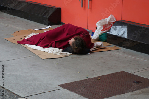 Fotografie Homeless man sleeping on a street. Vancouver, Canada.