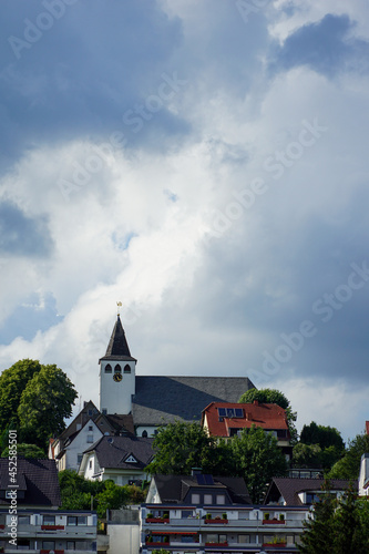 Vertical shot of a church and other buildings under ablue sky photo