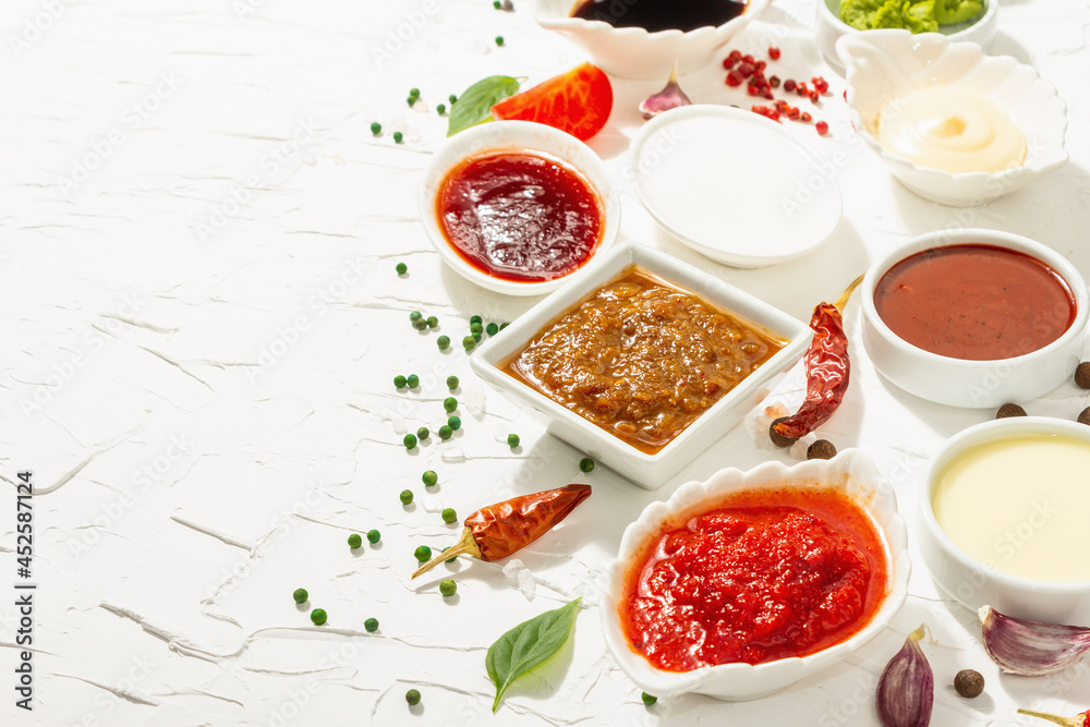 Set of different sauces - ketchup, mayonnaise, barbecue, soy, chutney, wasabi, adjika, horseradish Set of different sauces - ketchup, mayonnaise, barbecue, soy, chutney, wasabi, adjika, horseradish