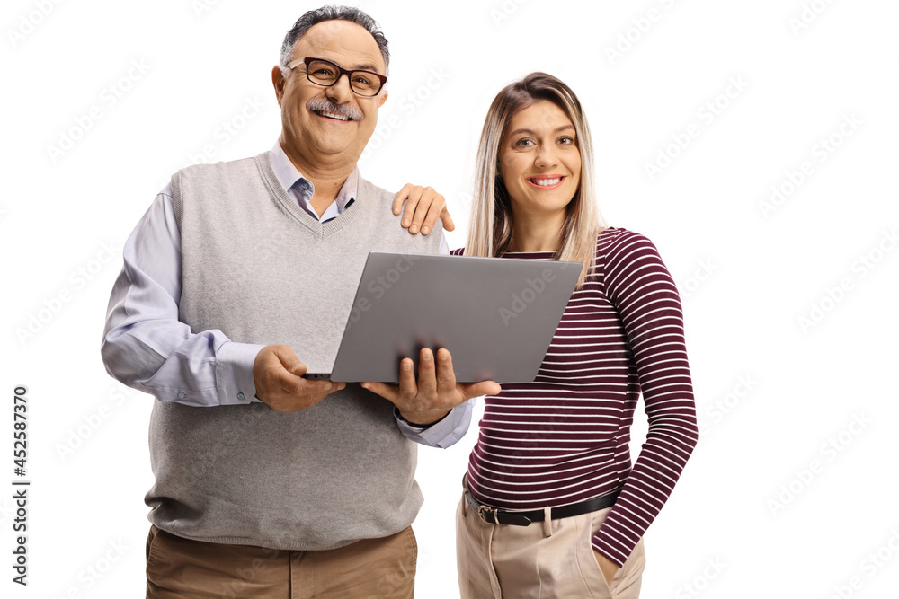 Young woman and an elderly man with a laptop computer looking at camera