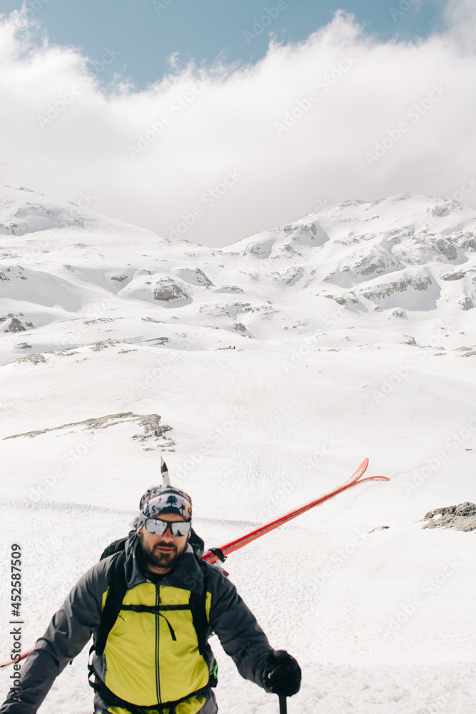Skier on rough mount with snow in winter
