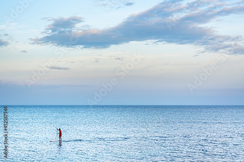 person training in the afternoon, in the mediterranean sea on alicante's summer days 