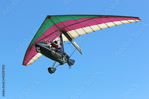 Valokuva Ultralight airplane flying in a blue sky