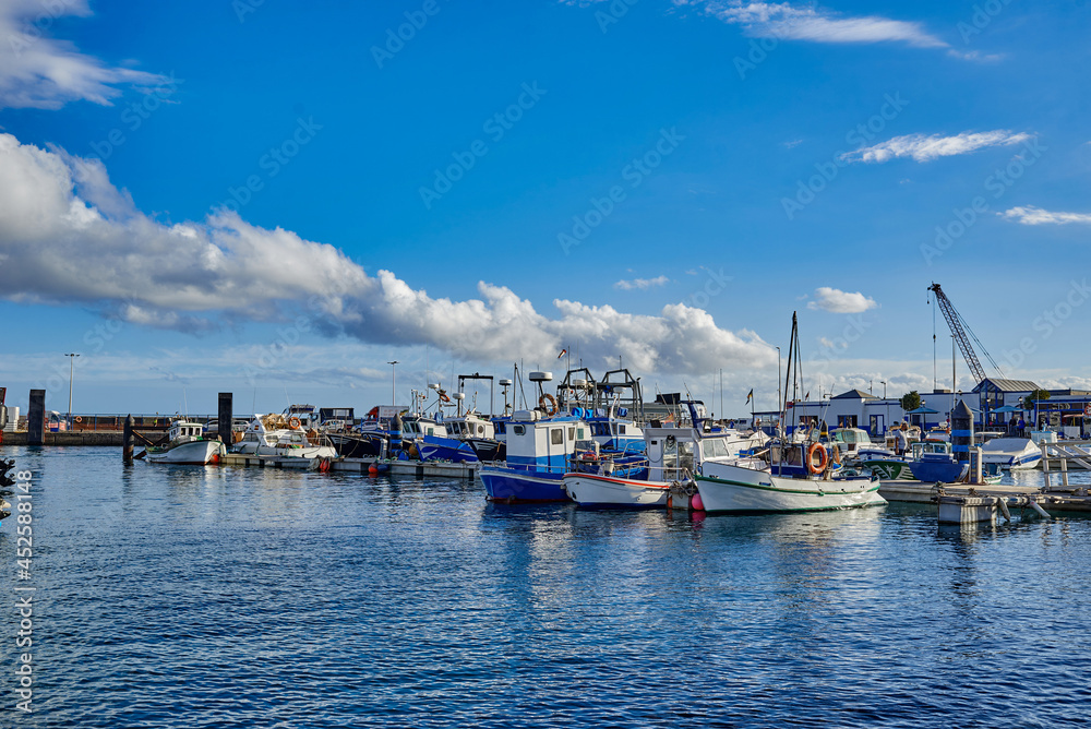 Colorful vessels located on coast near waving sea Colorful vessels located on coast near waving sea
