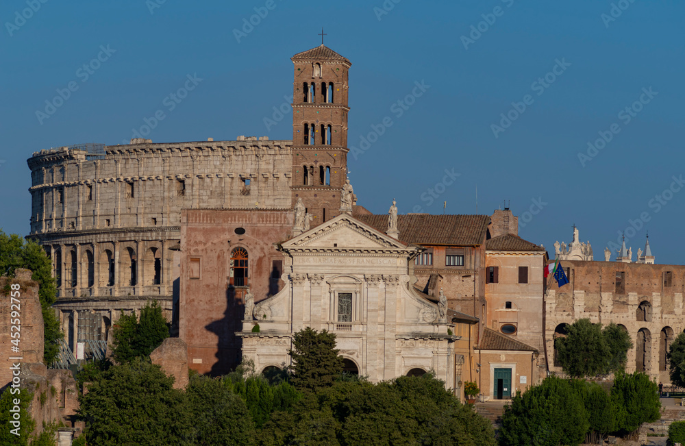 August 21, 2021
Late afternoon view of the Santa Francesca Romana church with the Colosseum in Rome Italy