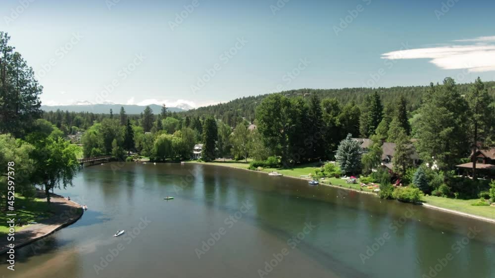 Aerial: People in rubbers tires floating on Mirror Pond, Bend, Oregon