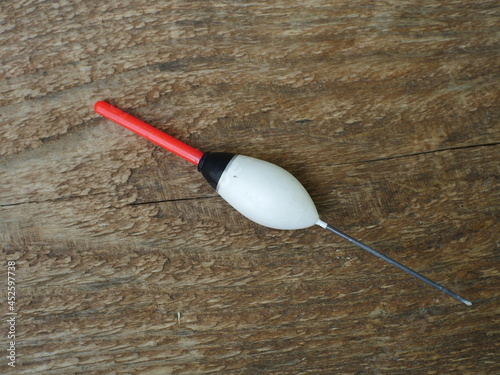 Tableau sur toile large white bobber with red antenna close-up, still life