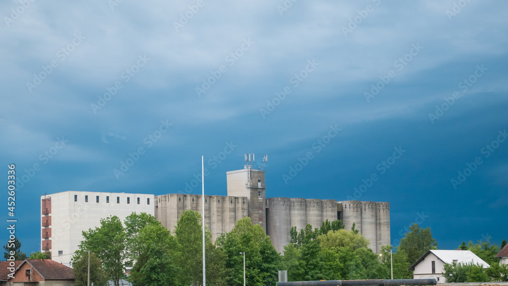 The concrete granary building in Križevci behind the blue sky