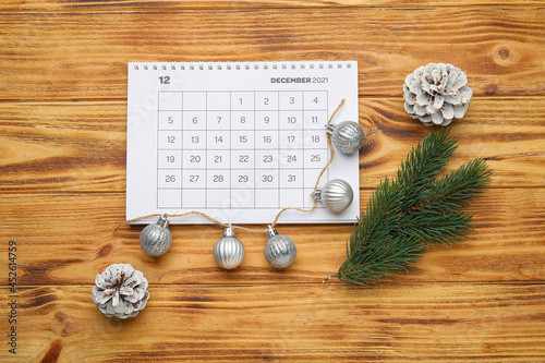Christmas composition with calendar on wooden background