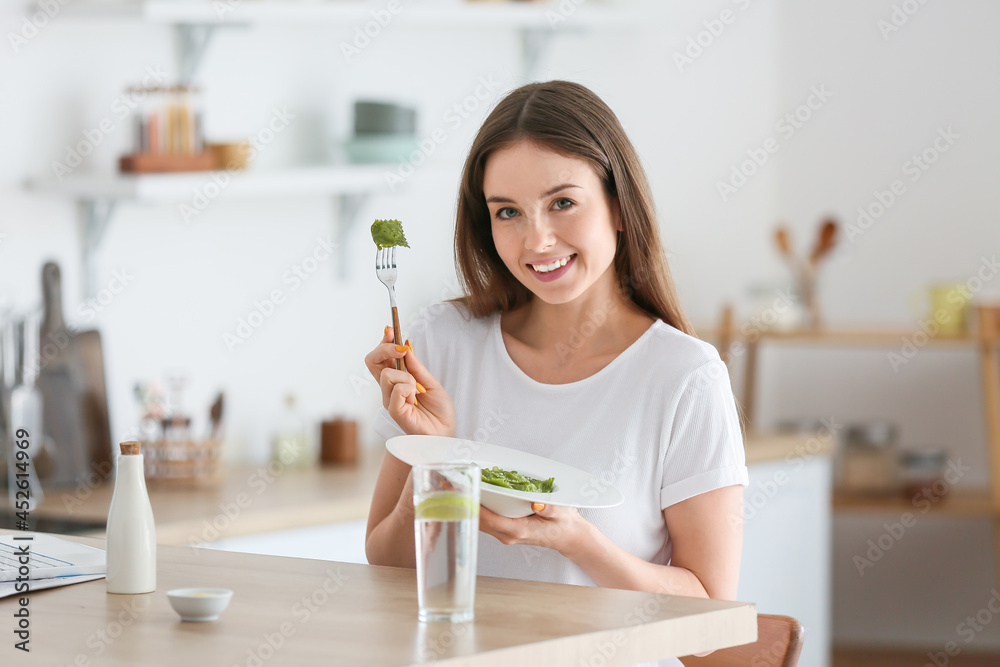 Beautiful young woman eating tasty ravioli at home Beautiful young woman eating tasty ravioli at home