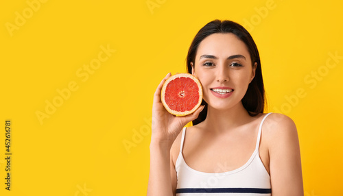 Smiling young woman holding...