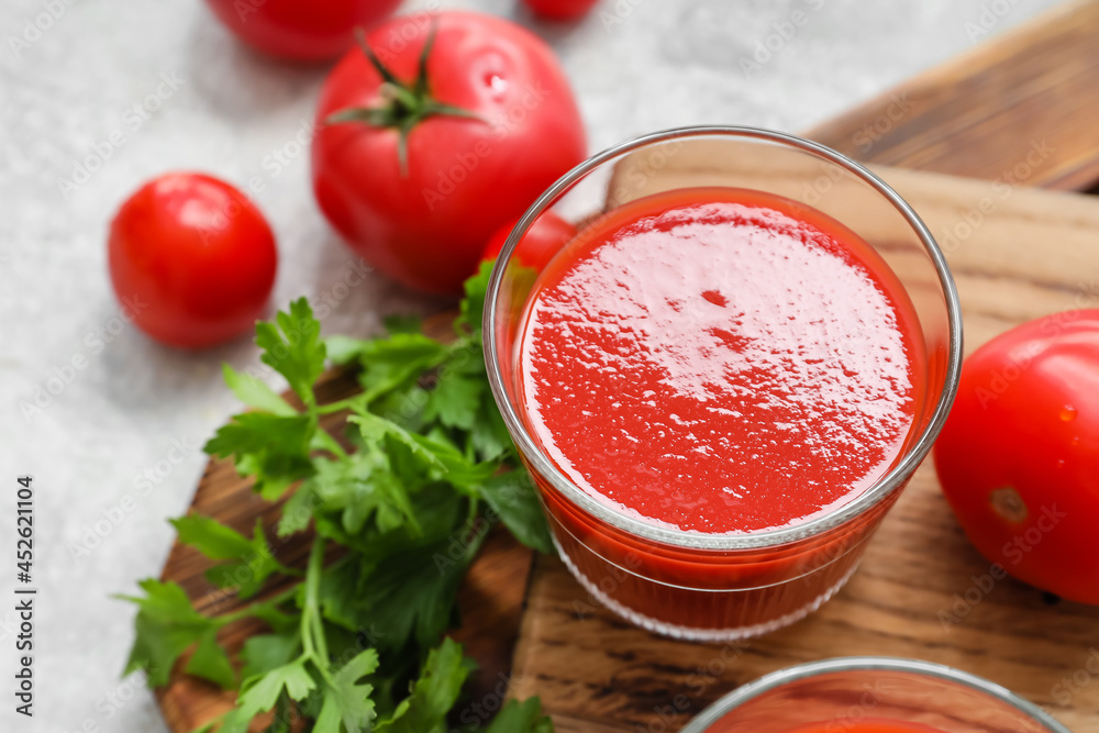 Glass of tasty tomato juice on light background Glass of tasty tomato juice on light background