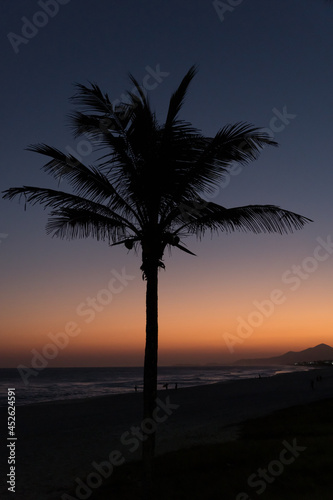 Sunset at Saquarema beach in Rio de Janeiro, Brazil. Famous for waves and surfing. Silhouette in low light.
