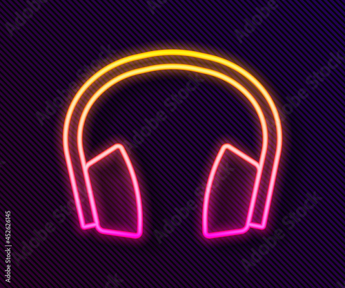 Glowing neon line Noise canceling headphones icon isolated on black background. Headphones for ear protection from noise. Vector