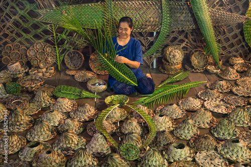 Canvas Print craftsman weaving hat basketry in Amphawa Thailand