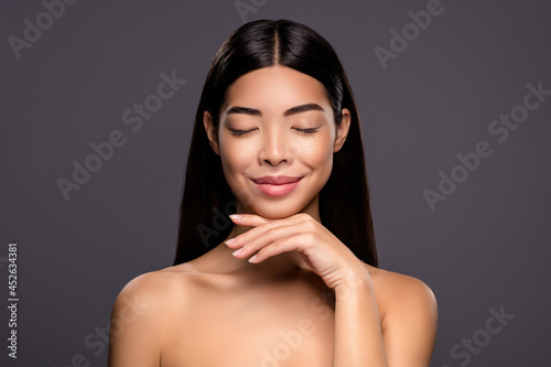 Photo of dreamy inspired model stunning korean brunette lady hand chin isolated grey color background