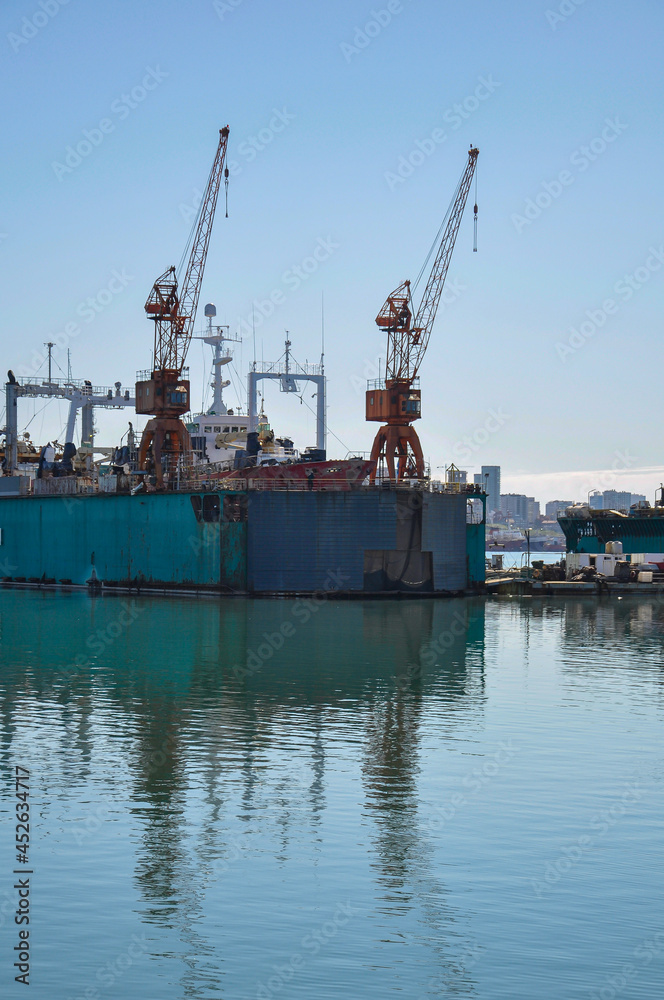 Two cranes on a floating dock in the port of Mar del Plata