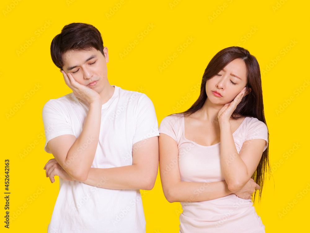 Young man and woman thinking about something.Isolated on yellow background. Young man and woman thinking about something.Isolated on yellow background.
