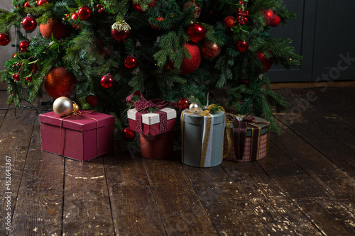 Gift boxes lie under a new year tree photo