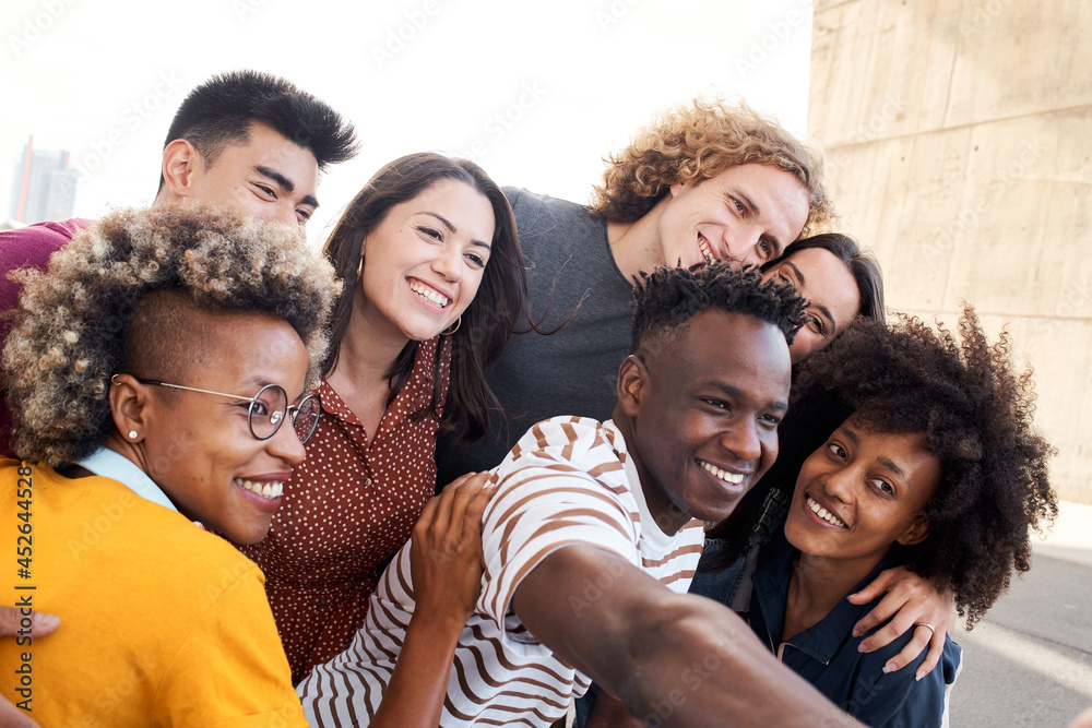 Multiethnic group of friends. Taking selfie outside. Caucasian, Asian, Latino, African American people. Concept joy, having fun, meeting friends.