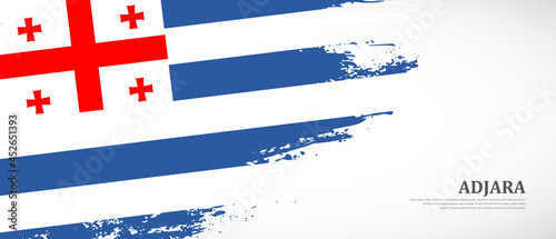 National flag of Adjara with textured brush flag. Artistic hand drawn brush flag banner background