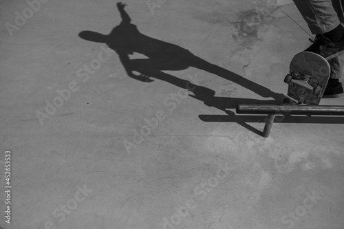 A skateboarder doing a boardslide in black and white. photo