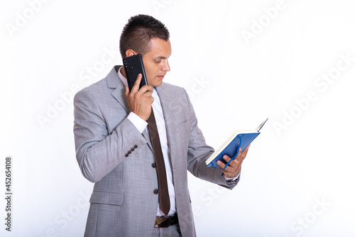 a young handsome businessman in a suit with a notebook © blanke1973