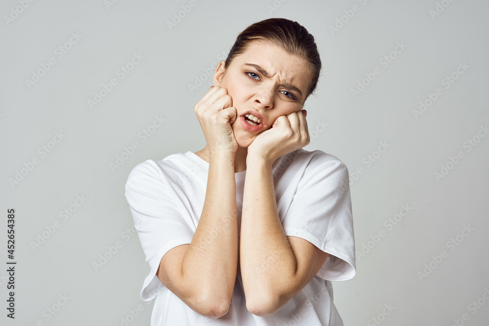 woman holding her head stress emotions discomfort pain close-up woman holding her head stress emotions discomfort pain close-up