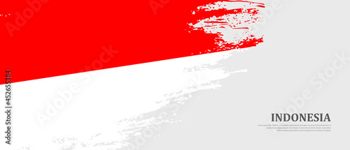 National flag of Indonesia with textured brush flag. Artistic hand drawn brush flag banner background