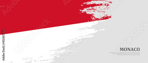 National flag of Monaco with textured brush flag. Artistic hand drawn brush flag banner background