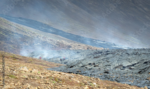 Grindavik, Iceland - July 26, 2021: A unique natural attraction. People are walking over the new lavafield of the volcano eruption at Fagradalsfjall