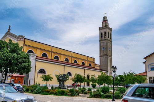 Shkoder, Albania - June 21, 2021: Pope John Paul II Square in Shkoder. Garden around St Stephen's Catholic Church on a city street photo