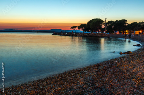 Fototapeta Naklejka Na Ścianę i Meble -  Sunset on the beach with clouds and trees