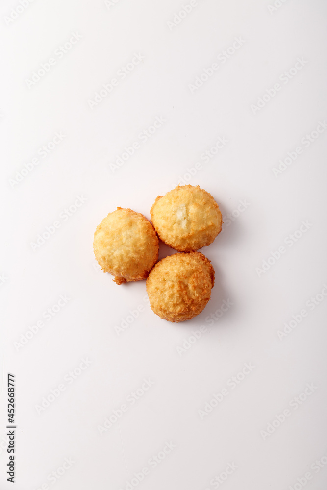 Toasted coconut cake on white background. Top view, flatlay. Nobody. Soft lighting Toasted coconut cake on white background. Top view, flatlay. Nobody. Soft lighting