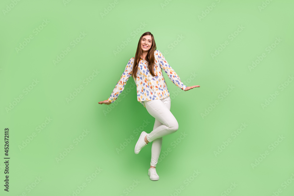 Full body photo of lovely brunette hairdo millennial lady stand wear blouse trousers sneakers isolated on green background Full body photo of lovely brunette hairdo millennial lady stand wear blouse trousers sneakers isolated on green background