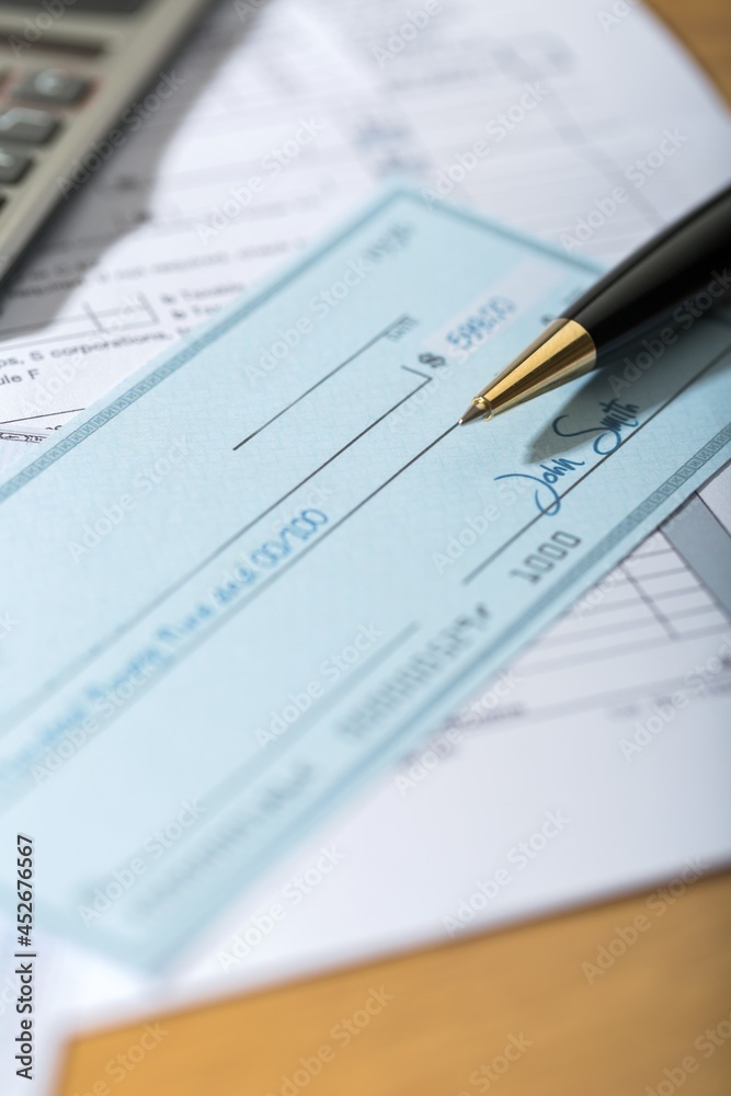 Tax Documents with Calculator,Cheque and Pen
