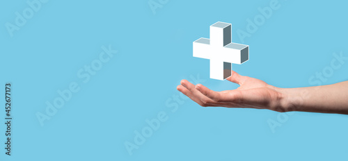 Fototapeta Naklejka Na Ścianę i Meble -  Hand hold 3D plus icon, man hold in hand offer positive thing such as profit, benefits, development, CSR represented by plus sign.The hand shows the plus sign
