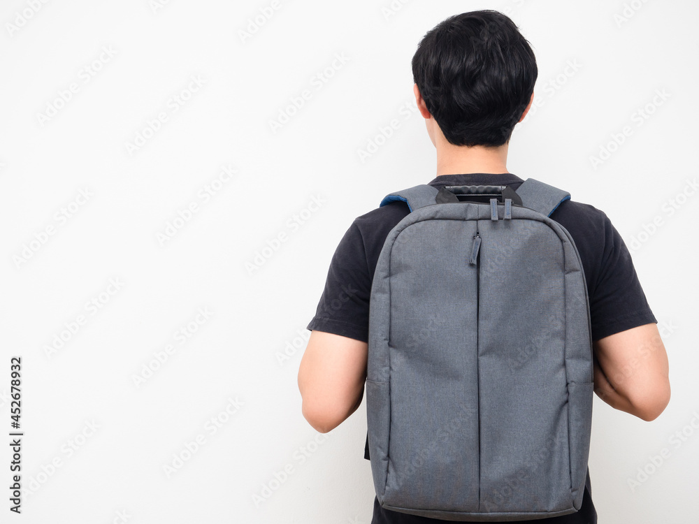 Fototapeta premium Man with school backpack stand turn back copy space white background back to school concept