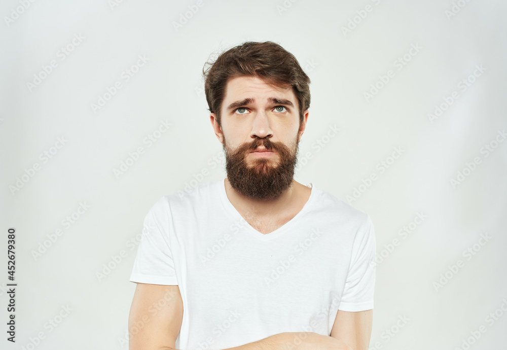 Man in a white t-shirt expressive look discontent Lifestyle Man in a white t-shirt expressive look discontent Lifestyle