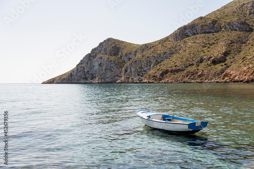 Small old boat anchored near the beach © Roberto