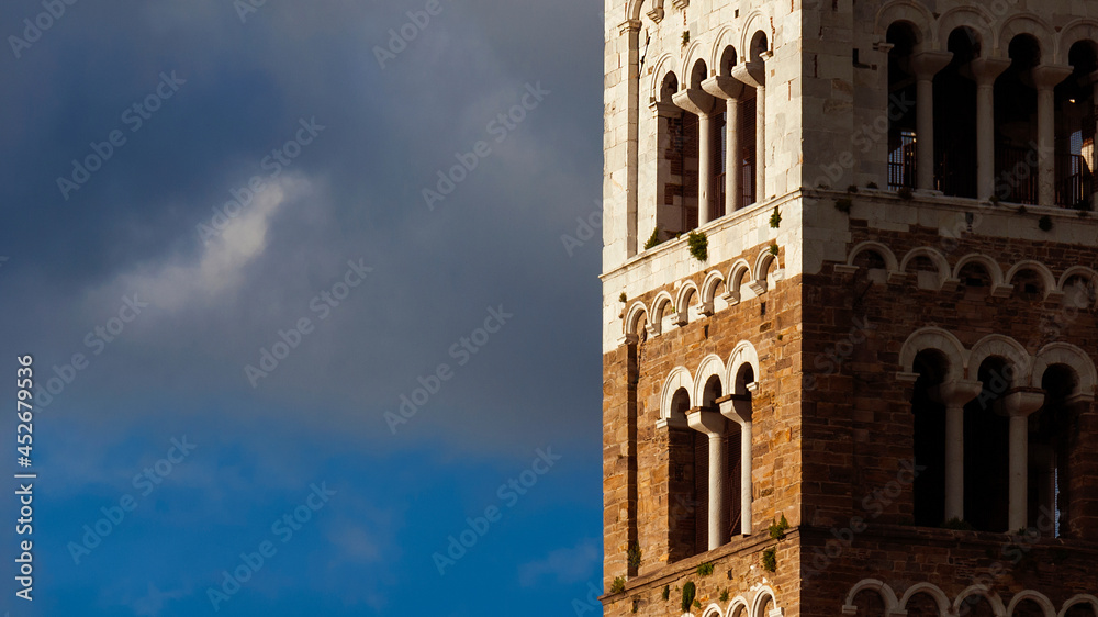 Lucca Cathedral old medieval bell tower exterior (with clouds and copy space)