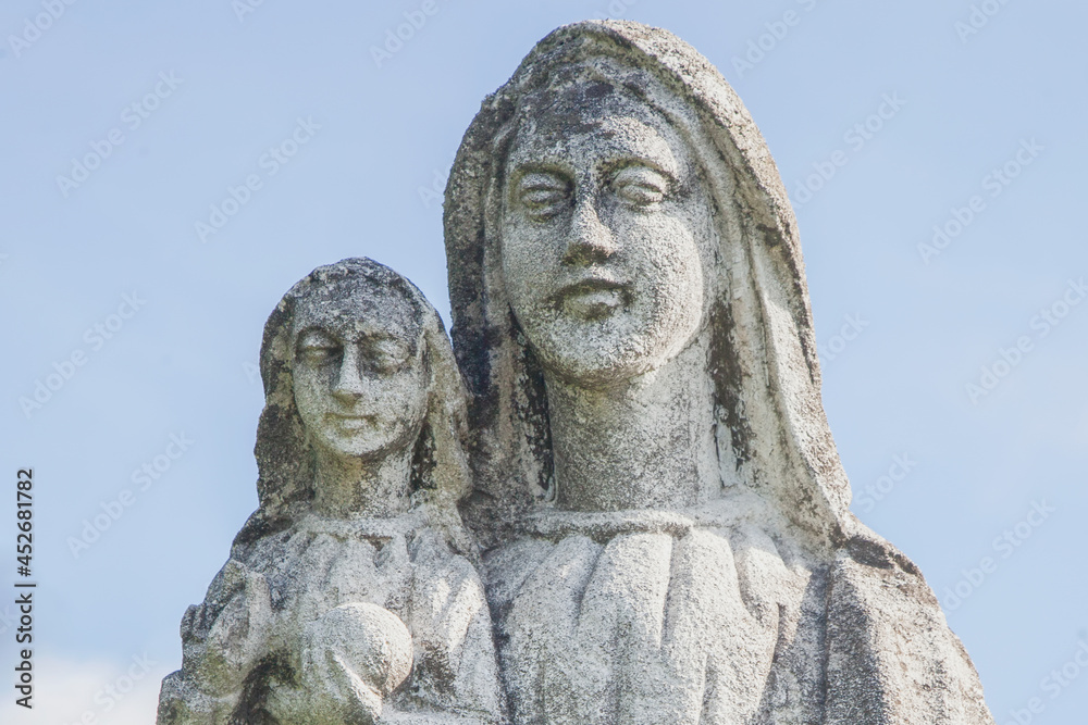 Very ancient stone statue of the Virgin Mary with the baby Jesus Christ