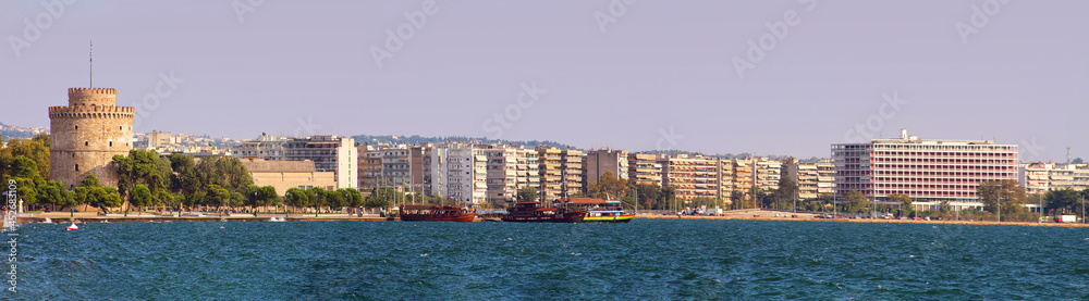 Panoramic view of white tower and seaside promenade in the evening in Thessaloniki, Greece