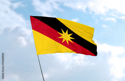 Flag of Sarawak, realistic 3d rendering in front of blue sky