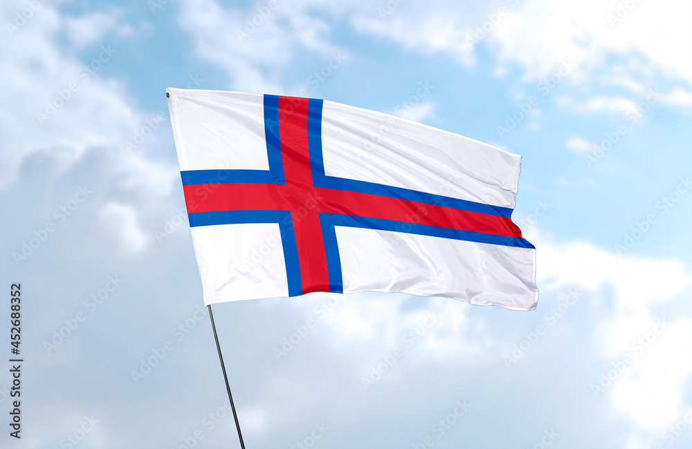 Flag of Faroe Islands, realistic 3d rendering in front of blue sky